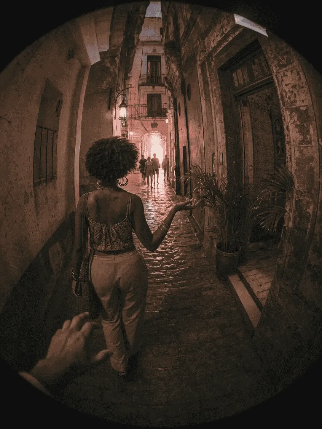 A traveler walking through a historic city street at night
